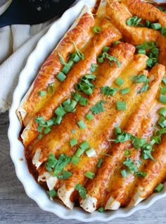 a casserole dish with meat, cheese and green garnish on top