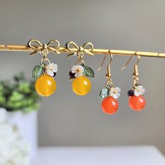 Our cute orange earring is made with natural jade, amethyst, acrylic leaves, acrylic flowers and 14k gold plated hooks which are good for delicate ears. We also offer matching necklace which is made with the same high-quality materials. Each natural jade bead is unique.Size: The length of the hook version is about 0.5" wide and 1.375" long The length of the stud version is about 0.5" wide and 1" long Citrus Jewelry, Beaded Fruit Jewelry, Acrylic Jewelry, Faery Jewelry, Diy Jewelry Earrings, Fruit Jewelry, Fruit Earrings, Nature Earrings, Food Earrings