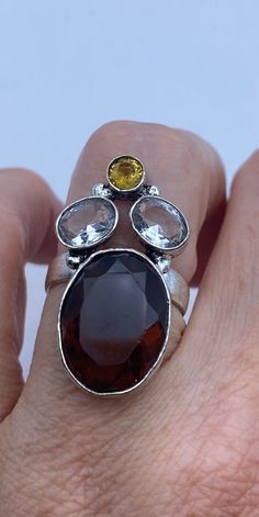 Golden Topaz and brownish garnet and clear quartz Setting handmade in low content silver  NOT 925  Size 5.5 can be resized, my jeweler charges $20  All rings are shipped free in the US in a nice gift box.   Check out our over a THOUSAND great reviews Engraving is $4 per letter and is not always perfect depending on the piece. It can take a few days if the jeweler is busy. This is payable to Paypal Judithsltd@gmail.com Sterling Silver Topaz Ring With Stones For Gift, Silver Topaz Ring With Stones For Gift, Silver Topaz Ring With Natural Stones As Gift, Multi-stone Topaz Gemstones As Gift, Cocktail Vintage, Multi Stone Ring, Multi Stone, Gmail Com, Cocktail Ring