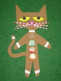 a paper cut out of a cat with candy on it's face and eyes