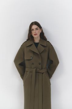 Our khaki trench coat showcases a slightly exaggerated silhouette, adding a unique and fashionable twist to a classic design. It features a notched collar and a double-breasted front fastening for a timeless look. The belted waist adds a touch of sophistication and allows for a customizable fit. With side slip pockets, you can keep your essentials within reach. Epaulettes on the shoulders add a stylish and military-inspired detail. Crafted with care and attention to detail, this Khaki trench coa Wedding Skirt Top, Silk Bridal Gown, Trench Coat Fall, Vision Book, Khaki Trench, Khaki Trench Coat, Cape Wedding Dress, Gown Skirt, Bridal Tops