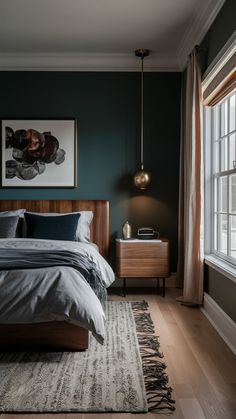 a bedroom with dark green walls and wooden furniture, along with a large rug on the floor