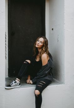 a woman sitting in a window sill with her legs crossed and the words how to keep your black jeans black