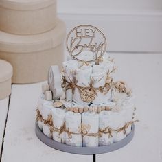 a three tiered cake with baby items on it