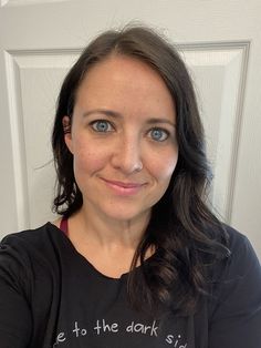 a woman wearing a black shirt with the words eat to the dark side on it