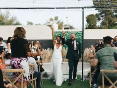 a bride and groom walking down the aisle after their wedding ceremony at an outdoor venue