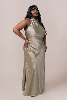 a woman in a gold dress posing for the camera with her hands on her hips