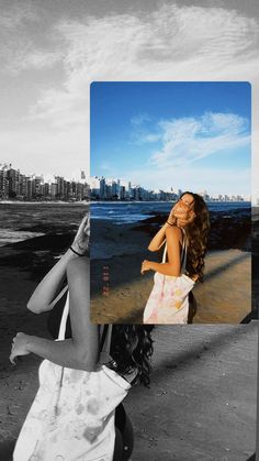 a woman walking down a beach next to the ocean with her hair blowing in the wind