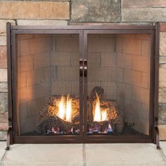 a fireplace with two lit logs in front of it