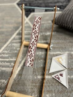 a weaving machine sitting on top of a rug