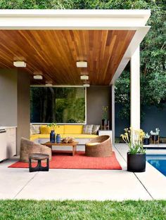 an outdoor living area next to a swimming pool