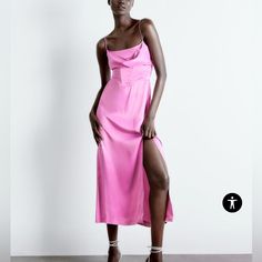 a woman in a pink dress posing for the camera