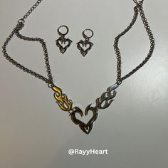 🔥 Two Piece Set - Flaming Heart Huggie Earrings & Y2K Necklace! 💔✨ 🎀  Get the ultimate Egirl style with this bold two piece set--featuring Flaming Heart Huggie Earrings and a matching Y2K Gothic Choker. This set is perfect for Y2K fashion lovers and anyone embracing the punk clothing and streetwear aesthetic. ❤️  This unique combo of a Fire Heart choker and edgy huggie earrings gives off serious Gothic Choker vibes. Whether you're dressing up your streetwear look or adding some fire to your e Earrings Y2k, Egirl Style, Unique Xmas Gifts, Flaming Heart, Gothic Choker, Y2k Necklace, Gothic Chokers, Punk Clothing, Y2k Accessories