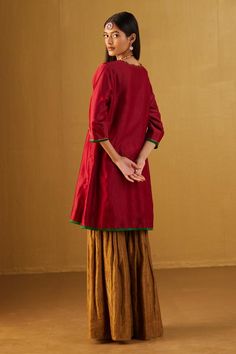 Red chanderi kurta embellished with heavy floral embroidered motifs. Comes with golden sharara.
Components: 2
Pattern: Embroidered
Type Of Work: Floral
Neckline: Scalloped V
Sleeve Type: Three Quarter
Fabric: Kurta: Chanderi: Sharara: Handloom Tissue, Lining: Shantoon
Color: Red
Other Details: 
2 side pockets on kurta
Partially elasticated waistband
Length:
Kurta: 35 inches
Sharara: 43 inches
Model height: 5ft 9inches, wearing size M
Note: Dupatta worn by the model is not for sale
Disclaimer: Si Golden Sharara, Kurta And Sharara Set, Kurta And Sharara, Red Kurta, Embroidered Motifs, Sharara Set, Set For Women, Aza Fashion, Model Height