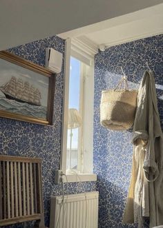 a bathroom with blue wallpaper and white radiator