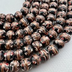 "A strand of handmade Venetian inspired trade bead style beads. a lovely smaller size that work well for bracelets - men love them in our store for their bracelet stacks. 47 beads 17 1/2\" of beads 44cm 10mm diameter on average 1.5 to 2mm hole" Artisan Polished Beads For Gifts, Round Spacer Beads For Gifts, Brown Wooden Beads For Jewelry Making, Traditional Large Beads For Gifts, Brown Beaded Bracelets With Round Beads For Gift, Artisan Beaded Bracelets With Spacer Beads As Gift, Traditional Beaded Bracelets For Jewelry Making, Bohemian Brown Beaded Bracelets With Oval Beads, Traditional Wooden Beads For Gifts