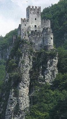 an old castle perched on top of a mountain