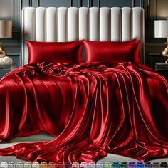 a bed covered in red sheets and pillows