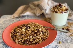 a bowl of granola next to a glass of milk