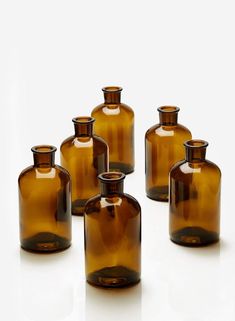 six brown glass vases sitting next to each other