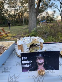 a cake sitting on top of a table next to a sign that says the under - cake