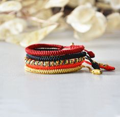 three different colored bracelets sitting on top of a table