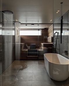 a bathroom with a tub, sink and shower stall in it's glass walls