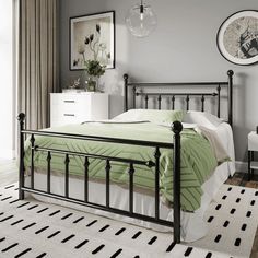 a bed room with a neatly made bed next to a dresser and window sill