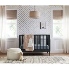 a baby's room with a crib, rocking chair and rug in it