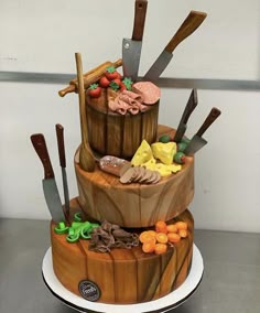 a three tiered cake made to look like a barrel with different types of food on it