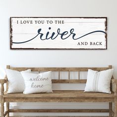 a wooden sign that says i love you to the river and back on a bench