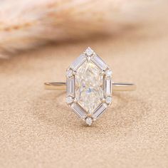 an image of a diamond ring on the sand