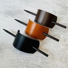 LEATHER HAIR BARRETTE WITH STICK Handmade vegetable tan leather hair barrette with stick. Super versatile for a casual up do - will hold your bun in place effortlessly!  DIMENSIONS Length 12cm  Width 4cm  Wooden Stick - 16.5cm WHILE YOU'RE HERE WHY NOT TAKE A LOOK AT OUR OTHER HAIR ACCESSORIES! https://www.etsy.com/shop/ScarlettSkyStudio?search_query=HAIR+ACCESSORIES Leather Hair Clips, Smartphone Bag, Leather Hair Accessories, Leather Scraps, Diy Book, Gold Leather, Hair Barrettes, Barrettes, Natural Leather