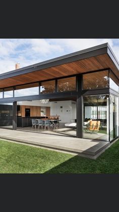 an open living room and dining area with sliding glass doors on the side of it