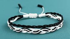 a black and white braid bracelet on a blue background