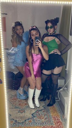 three women in costumes are taking a selfie