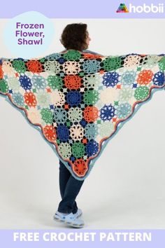 a woman is holding up a crocheted shawl with flowers on it and the text, frozen flower shawl free crochet pattern