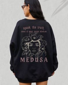 🐍THE GOTHIC MEDUSA BACK PRINT SWEATSHIRT 🐍 We are super excited for you to get your hands on this Medusa quote and design sweatshirt. The garment is very on trend, mixing the dark academia vibe with a Medusa quote in a gothic style. We hope you like it! Perfect for yourself or as a gift.  If you would like to discuss colour options for anything that isn't available in the listing, please let us know and message us directly.  THIS DESIGN IS ALSO AVAILABLE AS A T SHIRT: ➡️ ➡️ ➡️ https://www.etsy.com/listing/1491961613/medusa-shirt-greek-mythology-medusa ✨ ABOUT OUR CREWNECK SWEATERS ✨ Our crewneck sweaters are pure comfort and very soft. They are available in various different colors, as per the listing options. If you like the oversized look, like in some of our photos, please purchase be Oversized Graphic Print Sweatshirt Fan Apparel, Fan Apparel Hoodie Sweatshirt With Graphic Print, Oversized Fall Sweatshirt With Back Print, Oversized Sweatshirt With Back Print For Fall, Greek Goddess Medusa, Goddess Medusa, Snake Hoodie, Snake Sweater, Mythology Medusa