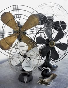 an old fan sitting on top of a table