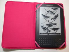 a pink kindle case with birds on it