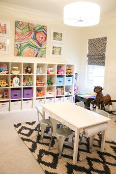 a child's playroom with toys and bookshelves