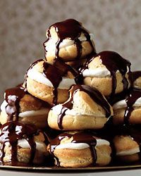 a pile of donuts covered in chocolate drizzle and marshmallows