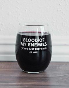 a wine glass that says blood of my enemies on it's side