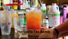 there is a person that is holding a drink in their hand with the words herbife tea bomb recipe on it