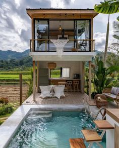 a house with a pool in the middle and an outdoor dining area next to it