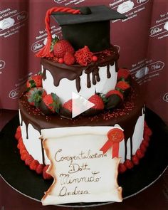 a graduation cake decorated with strawberries and chocolate