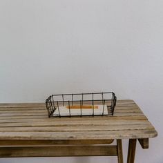 a small basket sitting on top of a wooden table