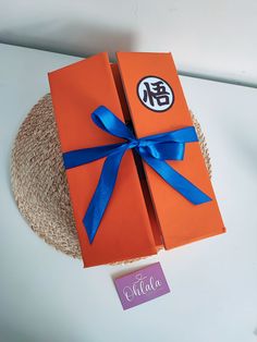 an orange box with blue ribbon on top