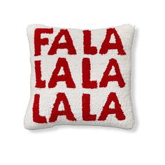 a red and white pillow with the words fala la la written in spanish on it