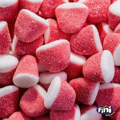 pink and white candy hearts are piled together